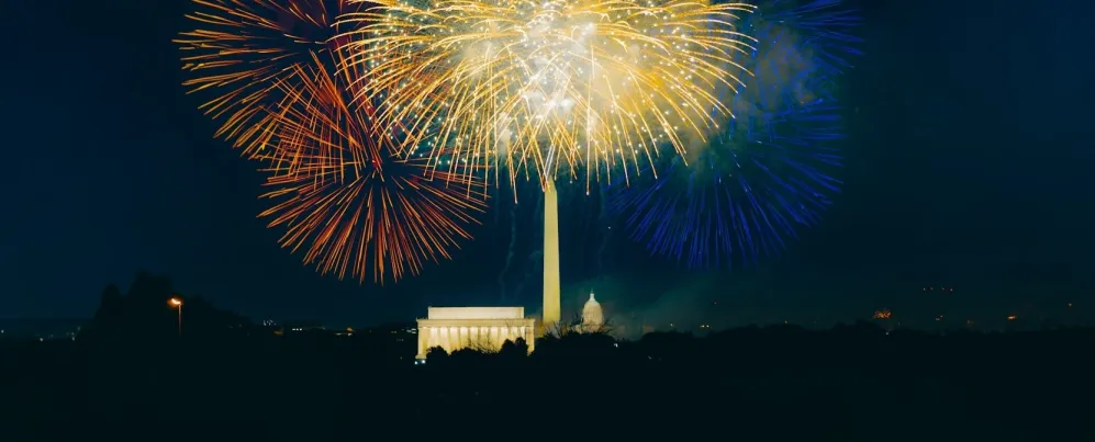 Colorful fireworks light up the night sky over the Washington Monument, Lincoln Memorial, and U.S. Capitol in Washington, DC, during a Fourth of July celebration.