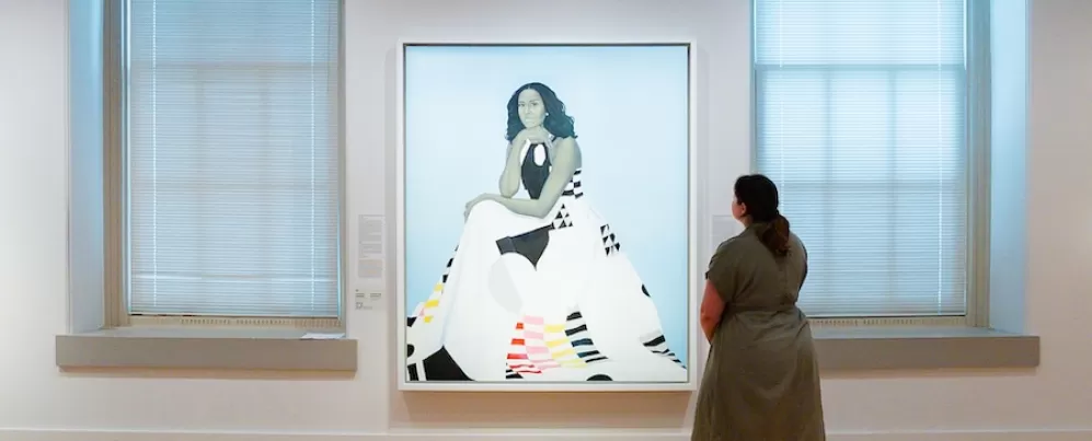 A woman gazes at a stylized portrait of Michelle Obama at the Smithsonian American Art Museum. 