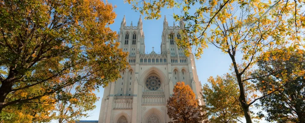 Washington National Cathedral framed by trees with fall colors.