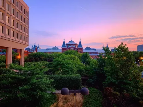 Sunrise over the Smithsonian’s Renaissance revival Arts & Industries Building as seen from the Department of Energy.