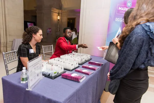 Destination DC Staffing Services redcoat assisting event attendee at registration - Staffing solutions for events in Washington, DC