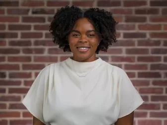 A woman smiles for a professional headshot. 